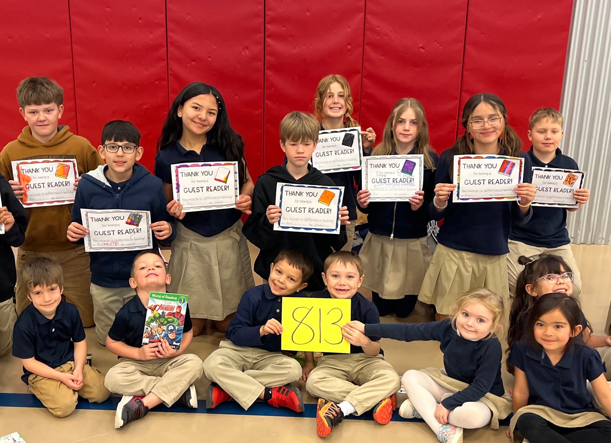 Students celebrating 813 books read as part of the Reading Buddies program at Pope John Paul II Academy