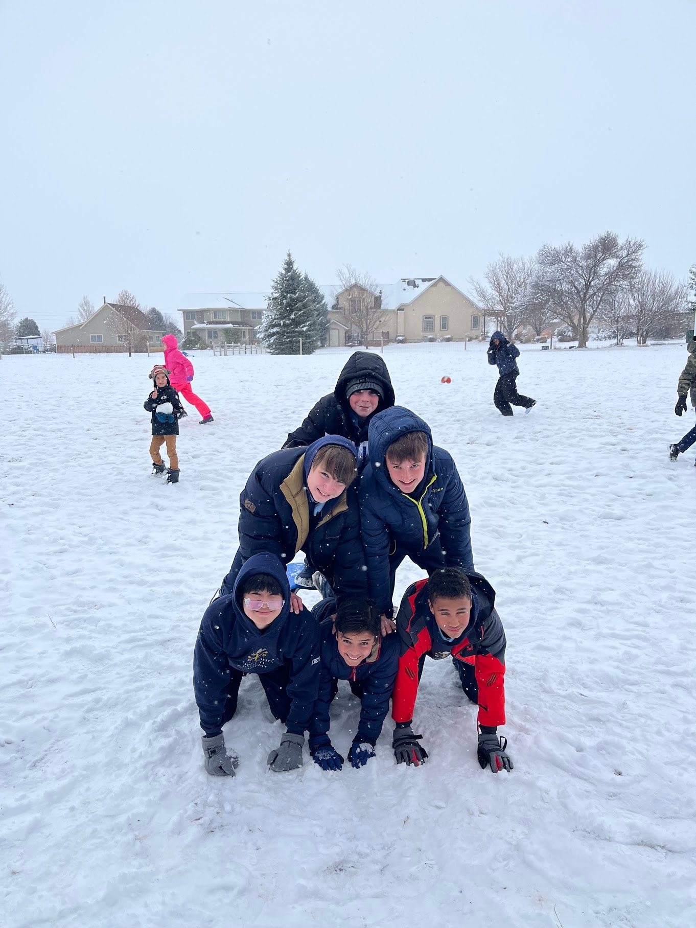 Students playing in the snow during winter recess at Pope John Paul II Academy